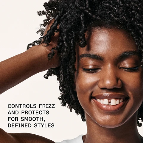 Image 1 - A smiling person with curly hair is touching their hair, and the image includes the text CONTROLS FRIZZ AND PROTECTS FOR SMOOTH, DEFINED STYLES.
Image 2 - A hand holding a bottle of OLAPLEX No. 6 Bond Smoother with a small amount of cream on the fingers, displaying text that reads 72 Hr FRIZZ CONTROL AND HUMIDITY RESISTANCE and additional product details.
Image 3 - Image shows a side-by-side comparison of curly hair labeled BEFORE on the left, depicting frizzy hair, and AFTER on the right, showing well-defined curls; visible text at the bottom includes UNTOUCHED IMAGES and additional product information about hair care results.
Image 4 - Side-by-side comparison of hair labeled BEFORE on the left showing dry, frizzy brown hair and AFTER on the right displaying smooth, well-defined waves with visible text below stating UNRETOUCHED IMAGES and product usage instructions.
Image 5 - Image shows two OLAPLEX hair care products: a white bottle labeled OLAPLEX No. 6 Bond Smoother and a yellow bottle labeled OLAPLEX No. 7 Bonding Oil, with text that reads Add OLAPLEX No. 7 for Frizz Control and Shine, Smooth Frizz + Hydrate, and Boost Shine + Softness.