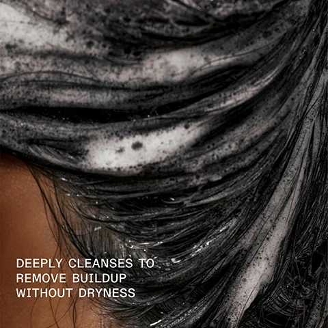 Image 1 - A close-up image of dark hair covered in foamy cleanser with the text deeply cleanses to remove buildup without dryness.
Image 2 - A close-up of a bottle of Olaplex No. 4C Bond Maintenance Clarifying Shampoo with bubbles on the surface and the text IMPROVES COLOR VIBRANCY, SHINE, AND SOFTNESS displayed on the image.
Image 3 - The image shows two side-by-side views of a persons hair, with the left side labeled BEFORE displaying frizzy, unkempt hair, and the right side labeled AFTER showing smooth, straight hair. Visible text states UNTouched IMAGES and provides details on the hair care products used.
Image 4 - Image shows a split comparison of curly hair labeled BEFORE on the left with frizzy, dull curls and AFTER on the right with smooth, defined curls; visible text at the bottom includes *Results achieved by cleansing with N°4C Bond Maintenance® Clarifying Shampoo, conditioning with N°8 Bond Intense Moisture Mask, and applying N°9 Bond Protector Nourishing Hair Serum to damp hair before styling.* and UNTouched IMAGES.
Image 5 - Image shows two hair care products side by side: a blue bottle labeled OLAPLEX N°4C BOND MAINTENANCE CLARIFYING SHAMPOO and a white bottle labeled OLAPLEX N°8 BOND INTENSE MOISTURE MASK, with accompanying text Pair With N°8 for a Weekly Reset, Deep Cleanse + Remove Buildup, and Replenish + Moisturize.