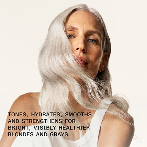 Image 1 - A woman with long, flowing silver hair is looking towards the camera, wearing a white top against a soft, light background, with visible text that reads TONES, HYDRATES, SMOOTH, AND STRENGTHENS FOR BRIGHT, VISIBLY HEALTHIER BLONDES AND GRAYS.
Image 2 - A bottle of OLAPLEX No.5P Blonde Enhancer Toning Conditioner with a light purple cap, featuring text that reads 91% AGREE HAIR WAS LESS BRASSY*, PATENTED TECHNOLOGY • OLAPLEX.COM, and an asterisk note about a consumer study.
Image 3 - A split image showing hair with two sections labeled BEFORE on the left and AFTER on the right, revealing a transformation from dull to shiny, healthy-looking hair with visible waves; text at the bottom explains that results may vary and lists product application instructions.
Image 4 - A side-by-side comparison showing hair before and after treatment; the left side shows frizzy, undefined curls, while the right side displays smooth, well-defined curls with the text BEFORE and AFTER labeled above each side, respectively, along with additional product information below.
Image 5 - Image showing a side-by-side comparison of hair before and after treatment, with BEFORE text on the left side representing dull, yellowish blonde hair and AFTER text on the right showing bright, cool-toned blonde hair; visible text below reads UNRETOUCHED IMAGES and *Results may vary. Results achieved by cleansing with N°4P Blonde Enhancer™ Toning Shampoo, conditioning with N°5P Blonde Enhancer™ Toning Conditioner, and applying N°9 Bond Protector Nourishing Hair Serum to damp hair before styling.
Image 6 - Two bottles of OLAPLEX hair products, with the left bottle labeled N°4P Blonde Enhancer Toning Shampoo and the right bottle labeled N°5P Blonde Enhancer Toning Conditioner, accompanied by the text Pair with N°4P for Bright, Strong Hair and Brighten + Strengthen on the left and Brighten + Smooth on the right.