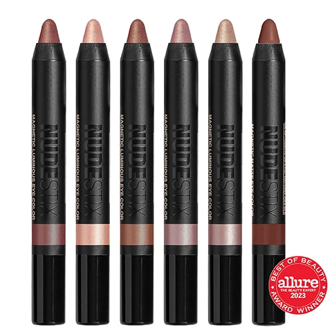 Image 1, best of beauty award winner - allure 2023. image 2, model shots of magnetic luminous eye in the shades - rustic grotto, nudity, burnish, pink seychelles, praia, maroon'd. image 3, swatches of nudity, pink seychelles, rustic grotto, burnish, praia and maroon'd on three different skin tones. image 4, swatches of nudity, pink seychelles, rustic grotto, burnish, praia and maroon'd. image 5, waterproof, smudge proof, easy to blend, quick drying, long wearing (11 hours), 3 in 1  multitasking cream formula = eyeshadow, eyeliner and eye primer. on the go stick application. clean, vegan and cruelty free. every kit comes with a recyclable tin and mirror. image 6, every palette comes with a tin. join a small movement and make a big difference. nudestix uses reusable tins for an important reason. we do not believe in single use watse. we encourage reusable and recyclable materials with environmentally friendly packaging. reuse your tin = organise your products and touch up makeup on the go. other things to store in your tin - jewellery, headsets etc. recycle with us = tinplate is the most infinitely recyclable material in the world that can be recycled into useful industrial products. recycle based on your local recycling centre. sharpener included.